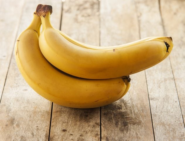 Bananas isolated on wooden background